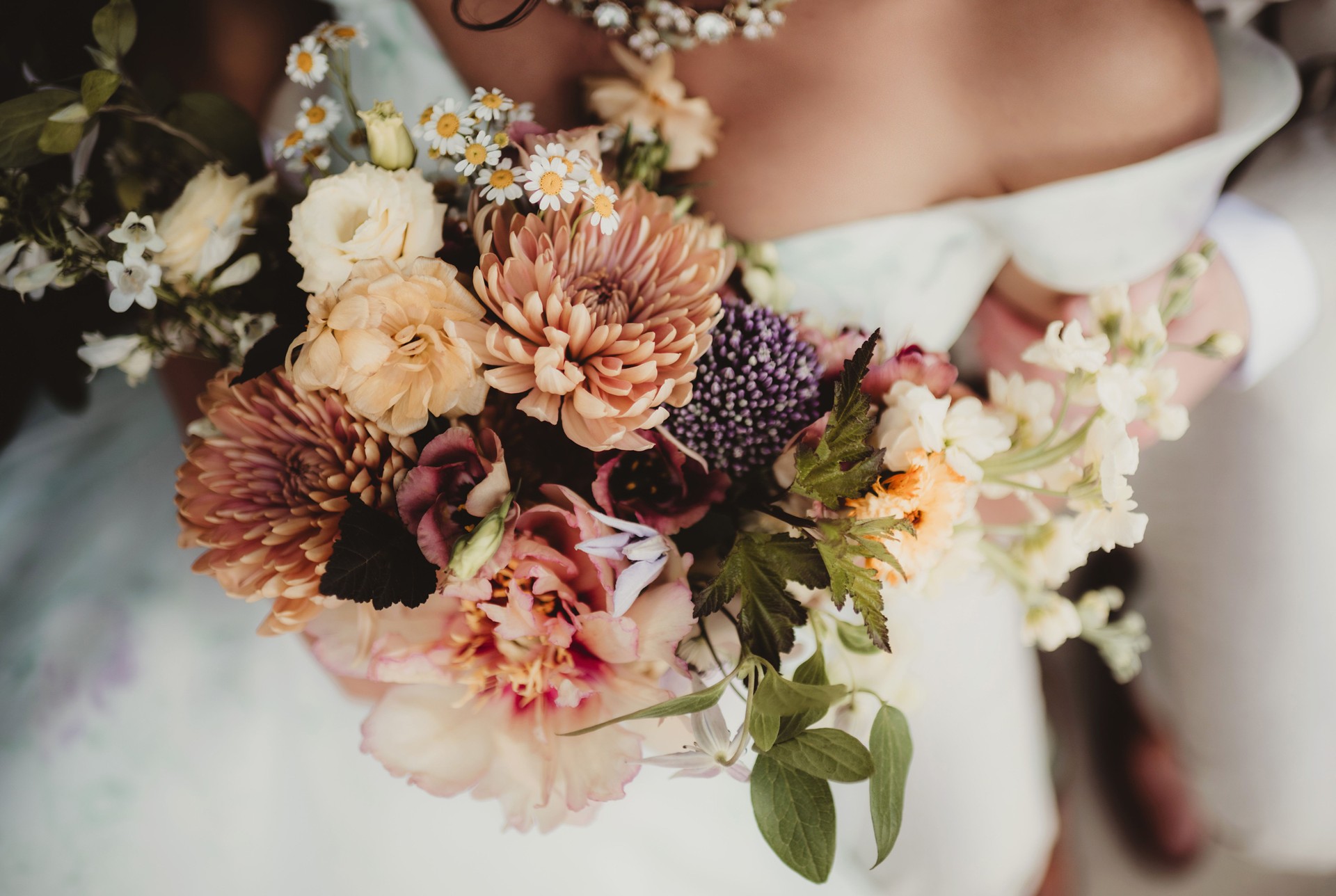 Bride holding bouquet of wedding flowers with dahlias and zinnias